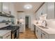 Well-lit kitchen featuring ample storage, stainless steel appliances and a sleek gas range at 1325 East Forrest Ave, East Point, GA 30344