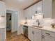 Updated kitchen boasts bright white cabinets, a stainless steel sink and subway tile backsplash at 1325 East Forrest Ave, East Point, GA 30344