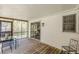 Spacious screened-in porch with a wooden deck, perfect for outdoor relaxation and dining at 1325 East Forrest Ave, East Point, GA 30344