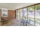 Inviting screened-in porch with exposed brick, offering an outdoor dining area for entertaining at 1325 East Forrest Ave, East Point, GA 30344