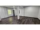 Bright basement with wood-look flooring, support beams, and natural light from a window at 185 Glenrose Sw Cir, Atlanta, GA 30354