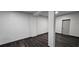Finished basement with modern laminate flooring, neutral walls, and convenient access door at 185 Glenrose Sw Cir, Atlanta, GA 30354