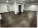 Spacious basement area with wood-look flooring and white support beams at 185 Glenrose Sw Cir, Atlanta, GA 30354