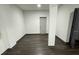 A neutral basement space featuring wood-look flooring and support columns at 185 Glenrose Sw Cir, Atlanta, GA 30354