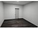 Finished basement with a door, modern laminate flooring, and neutral walls at 185 Glenrose Sw Cir, Atlanta, GA 30354