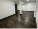 Large basement with wood-look floors, white support columns, and a modern aesthetic at 185 Glenrose Sw Cir, Atlanta, GA 30354
