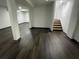 Finished basement area with modern laminate flooring and stairs at 185 Glenrose Sw Cir, Atlanta, GA 30354