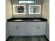 Bathroom featuring double sinks, a vanity with lighting, and storage at 185 Glenrose Sw Cir, Atlanta, GA 30354