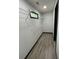 Bright walk-in closet featuring wood flooring, white wire shelving, and a window at 185 Glenrose Sw Cir, Atlanta, GA 30354
