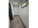 Bright walk-in closet featuring wood flooring, white wire shelving, and a window at 185 Glenrose Sw Cir, Atlanta, GA 30354