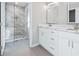 Modern bathroom showcasing double sinks, marble counters, and a frameless glass shower at 3180 Tackett Rd, Douglasville, GA 30135