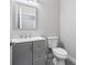 Bathroom featuring a gray vanity, sink, and toilet at 3180 Tackett Rd, Douglasville, GA 30135