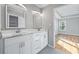 Contemporary bathroom featuring double sinks, marble counters, and access to Primary bedroom at 3180 Tackett Rd, Douglasville, GA 30135