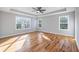 Spacious bedroom featuring wood floors, a trey ceiling with fan, and multiple bright windows at 3180 Tackett Rd, Douglasville, GA 30135