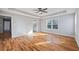 Inviting bedroom with beautiful hardwood floors, neutral paint, and a view to the bath at 3180 Tackett Rd, Douglasville, GA 30135