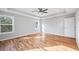 Sunlit bedroom with beautiful wood floors, a fan, and a scenic view from large windows at 3180 Tackett Rd, Douglasville, GA 30135