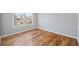 Bright bedroom features hardwood floors, base trim, and large window overlooking the neighborhood at 3180 Tackett Rd, Douglasville, GA 30135