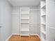 Walk-in closet with custom shelving, offering ample storage space and wood flooring at 3180 Tackett Rd, Douglasville, GA 30135