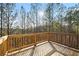 Wooden deck surrounded by lush trees, perfect for outdoor enjoyment and relaxation at 3180 Tackett Rd, Douglasville, GA 30135