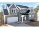 Two-story home featuring neutral siding, a dark roof, white trim, and an attached two-car garage at 3180 Tackett Rd, Douglasville, GA 30135