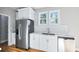 Kitchen area featuring stainless appliances, granite countertops, and white cabinetry at 3180 Tackett Rd, Douglasville, GA 30135