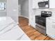 Modern kitchen with stainless steel appliances, granite countertops, and stylish hardwood floors at 3180 Tackett Rd, Douglasville, GA 30135