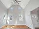 Bright living room featuring a vaulted ceiling, hardwood floors, and natural light at 3180 Tackett Rd, Douglasville, GA 30135