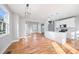 Open-concept living space with hardwood floors and modern lighting at 3180 Tackett Rd, Douglasville, GA 30135