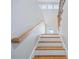 Bright staircase features wood treads and a white painted riser and light grey walls at 3180 Tackett Rd, Douglasville, GA 30135