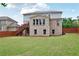 A spacious backyard with a deck, patio, and lush green lawn at 3570 Terrasol Sw Trl, Lilburn, GA 30047
