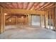 Unfinished basement with wooden beams and concrete flooring at 3570 Terrasol Sw Trl, Lilburn, GA 30047