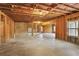 Unfinished basement space with exposed beams and a concrete floor at 3570 Terrasol Sw Trl, Lilburn, GA 30047