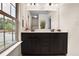 Bathroom featuring a dark cabinet, double vanity, and decorative accents at 3570 Terrasol Sw Trl, Lilburn, GA 30047