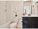 A bright bathroom includes a toilet, shower/tub combo, and black vanity with white countertop at 3570 Terrasol Sw Trl, Lilburn, GA 30047