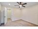 Bright bedroom featuring a ceiling fan, neutral carpet, and a door leading to additional space at 3570 Terrasol Sw Trl, Lilburn, GA 30047