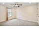 Bright, carpeted bedroom with a ceiling fan and a window providing a view of the outside at 3570 Terrasol Sw Trl, Lilburn, GA 30047