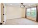 Bright bedroom featuring neutral carpet, ceiling fan, and large window with outdoor views at 3570 Terrasol Sw Trl, Lilburn, GA 30047