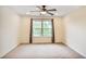 Neutral bedroom with a ceiling fan and a large window bringing in natural light at 3570 Terrasol Sw Trl, Lilburn, GA 30047