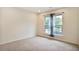 Cozy bedroom with neutral carpet, a window with sheer curtains, and ample natural light at 3570 Terrasol Sw Trl, Lilburn, GA 30047