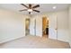 Well-lit bedroom with bathroom access, neutral carpet, and ceiling fan, ideal for relaxation at 3570 Terrasol Sw Trl, Lilburn, GA 30047