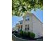 Charming brick two-story home with manicured landscaping, under a leafy green tree at 3570 Terrasol Sw Trl, Lilburn, GA 30047