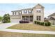 Charming two-story home with a well-manicured lawn and a mix of brick and siding at 3570 Terrasol Sw Trl, Lilburn, GA 30047