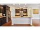 Modern kitchen features granite countertops, stainless steel appliances, and dark wood cabinetry at 3570 Terrasol Sw Trl, Lilburn, GA 30047