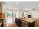 Spacious kitchen island with granite countertops and stainless steel appliances overlooks living area at 3570 Terrasol Sw Trl, Lilburn, GA 30047