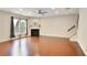 Spacious living room featuring hardwood floors, a fireplace, and staircase, filled with natural light at 3570 Terrasol Sw Trl, Lilburn, GA 30047