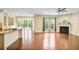 Open living area with hardwood floors, a fireplace, and a seamless flow to the kitchen at 3570 Terrasol Sw Trl, Lilburn, GA 30047