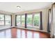 Sunlit living space boasts large windows and hardwood flooring at 3570 Terrasol Sw Trl, Lilburn, GA 30047