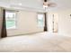 A carpeted primary bedroom features two large windows and recessed lighting at 3570 Terrasol Sw Trl, Lilburn, GA 30047