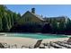 Community pool with lounge chairs and a view of the clubhouse on a sunny day at 3570 Terrasol Sw Trl, Lilburn, GA 30047