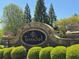 Stone community sign for TerraSol surrounded by manicured green bushes and lush trees at 3570 Terrasol Sw Trl, Lilburn, GA 30047
